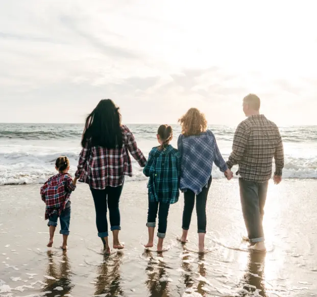 Family walking on beach representing connection and togetherness