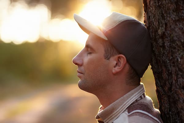 Man outdoors reflecting during personal growth and healing journey