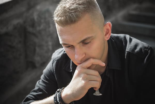 Young man looking thoughtful during mental health struggle